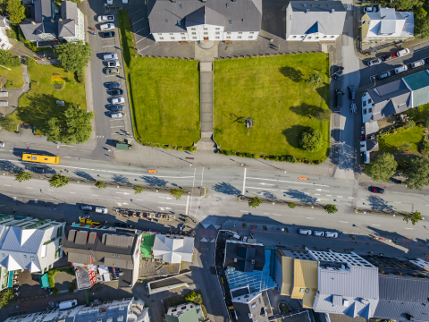 Aerial view of a road, cars and buildings.