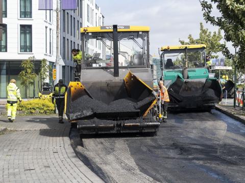 Large equipment paving a street