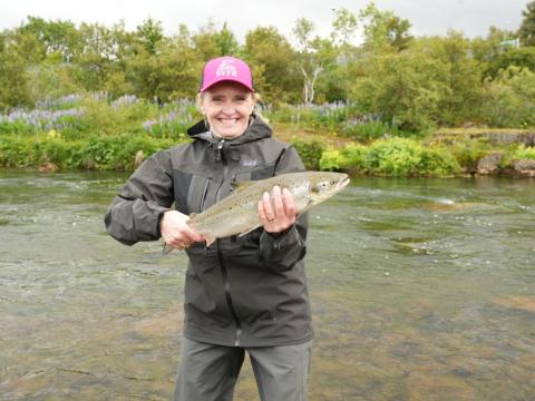 Mayor Heiða Björg Hilmisdóttir with the salmon she caught at this morning's opening of the Elliðaár rivers.