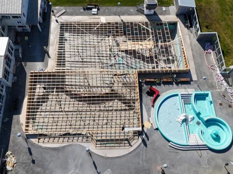 Maintenance work underway beneath a temporary structure at Vesturbæjarlaug.