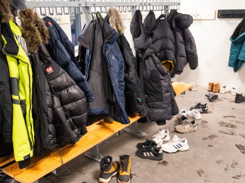 School coat rack full of teenage jackets. 
