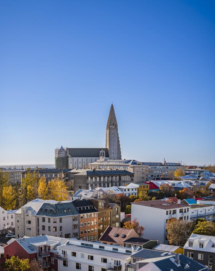Image of houses and Hallgrímskirkja. Blue sky.