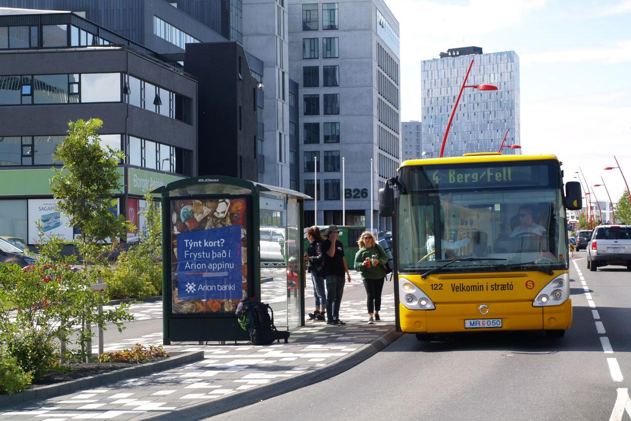 A public bus driving down Borgartún