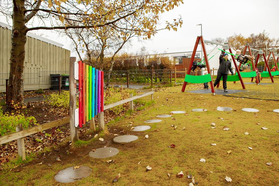 Children swinging on the grounds of Kvistaborg.