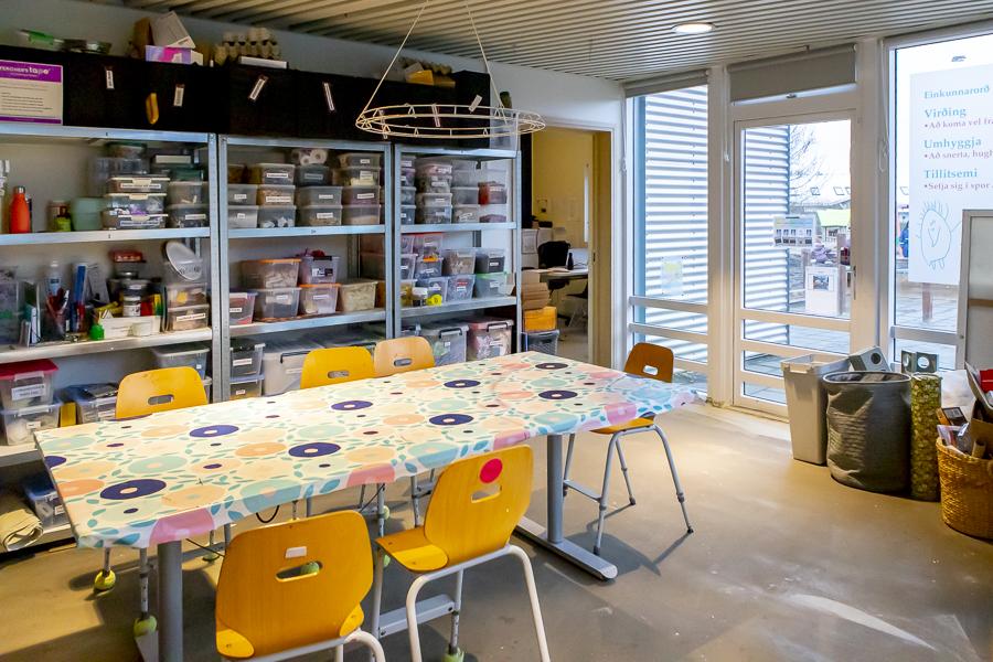 Art creation and craft room with a large table and chairs.
