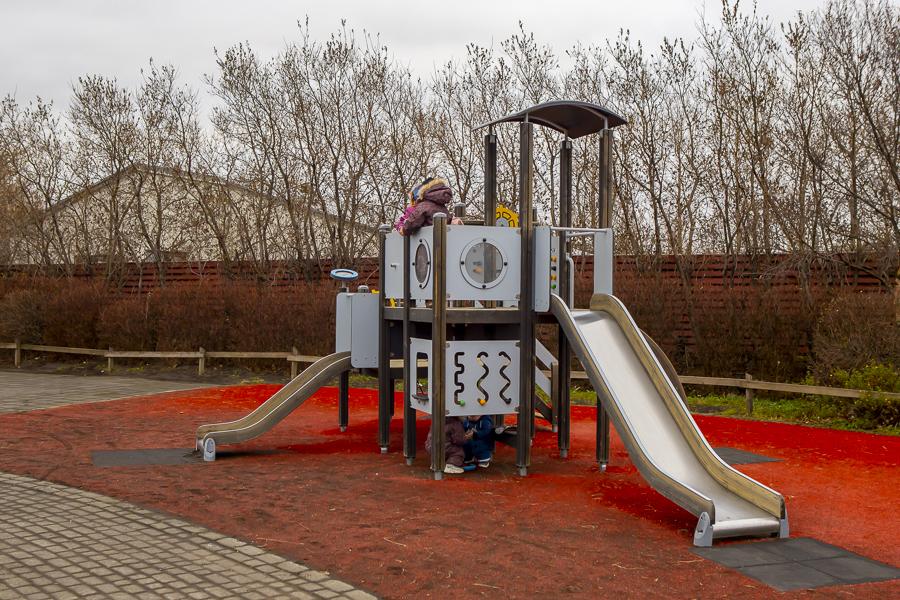 Outdoor slide and castle with children playing. 
