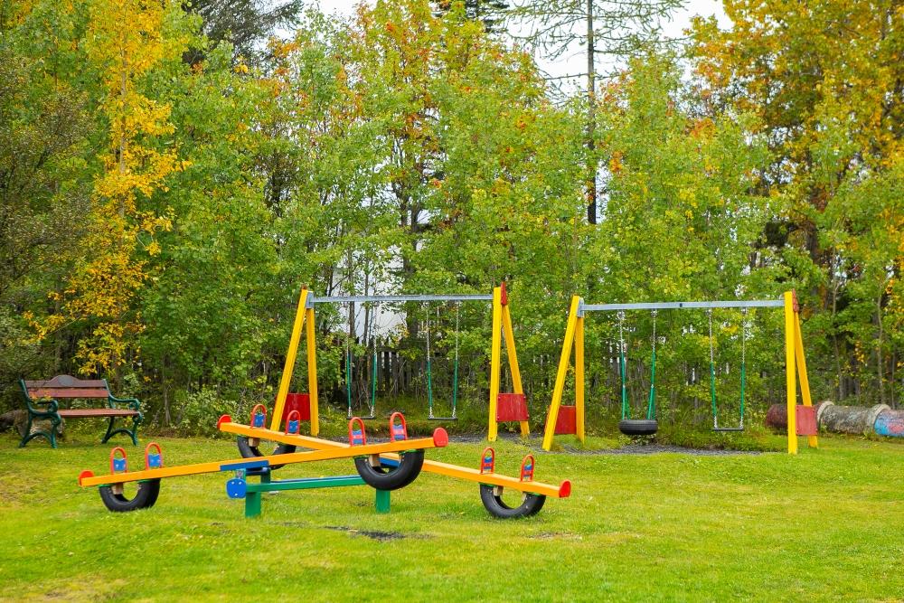 Swings and seesaw on the Steinahlíð playground. 