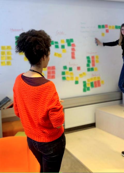Workshop participant looking at ideas on the wall.