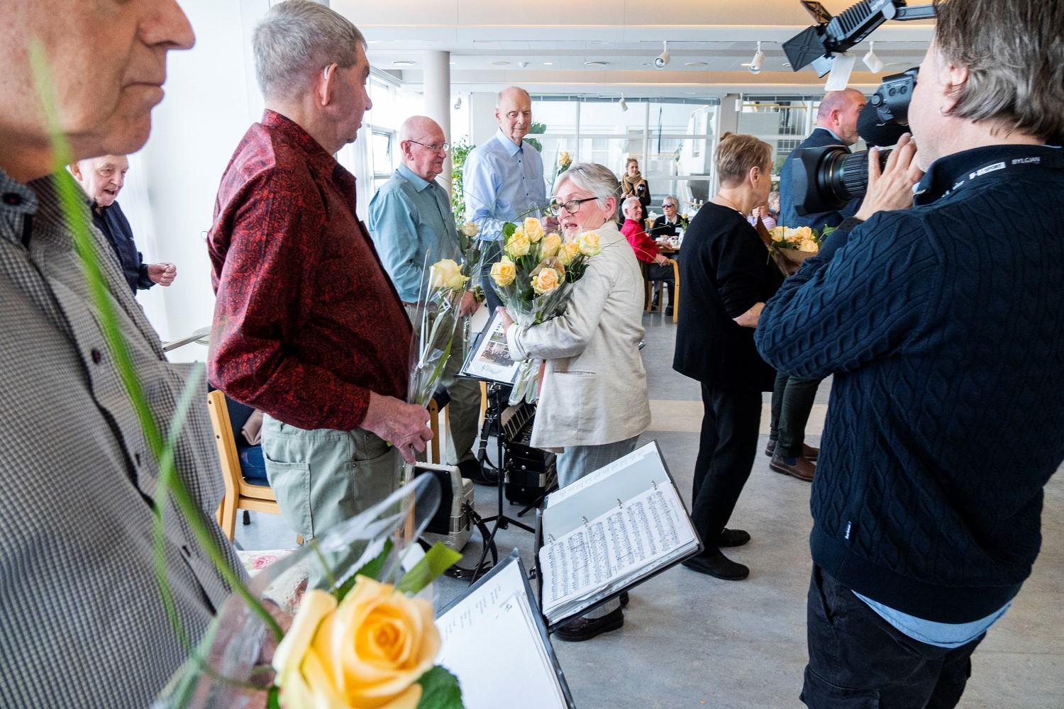 Helga Óskarsdóttir veitir meðlimum blóm.