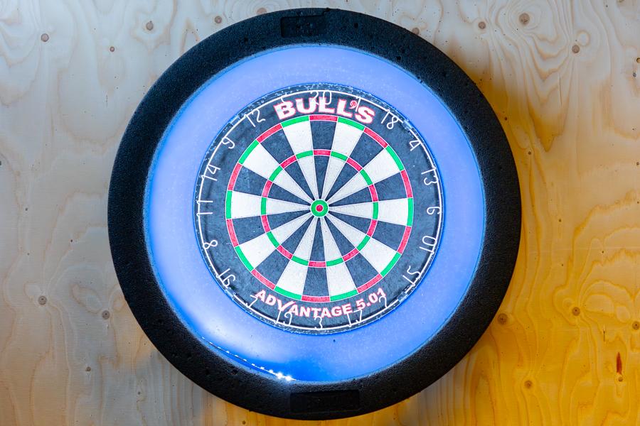Dartboard mounted on the wall. 