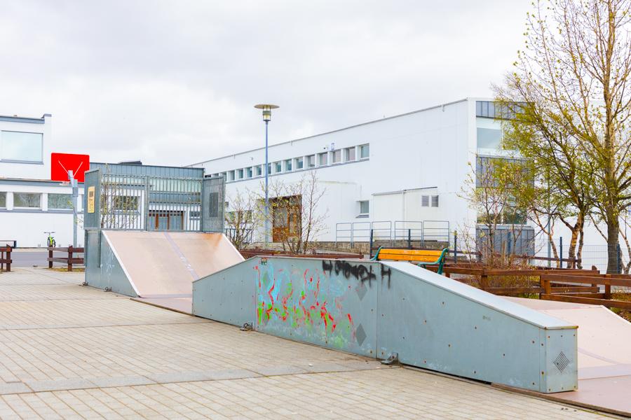 A skateboard ramp in a schoolyard. 
