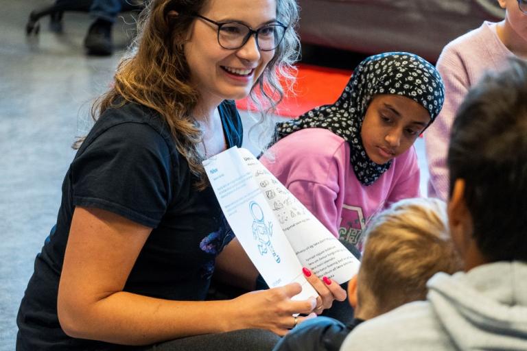 A teacher at Vesturbæjarskóli guiding children in the Shared Voices project