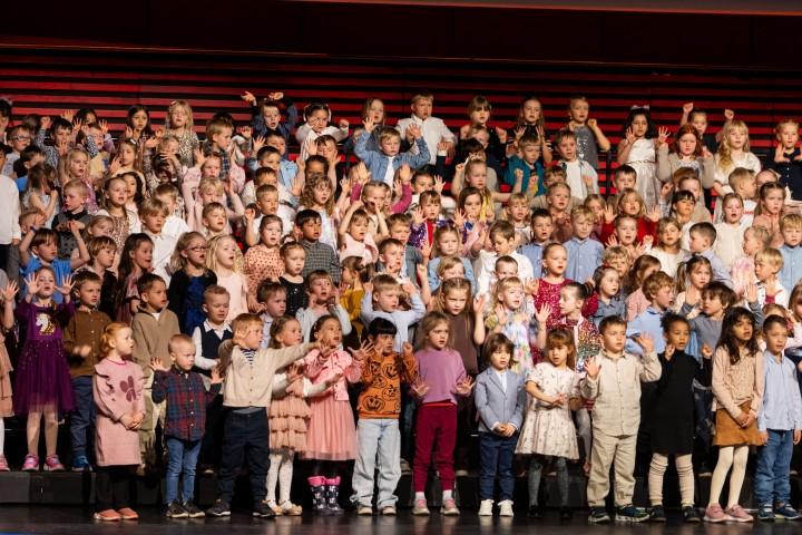The children dressed up and poised on stage.
