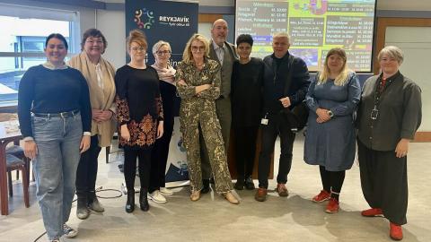 Group photo of participants at a welfare coffee event with Welfare Council officers.