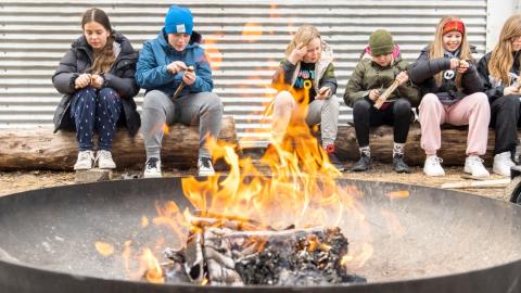 Children sitting around a campfire.