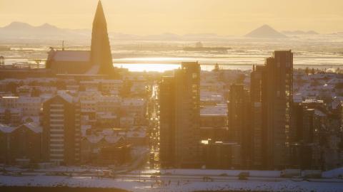 aerial view of Sæbraut and Hallgrímskirkja. Winter, late afternoon sun. Keilir and Reykjanes visible in the distance.