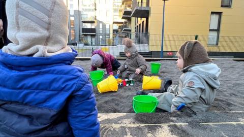 Children playing in a sandbox.
