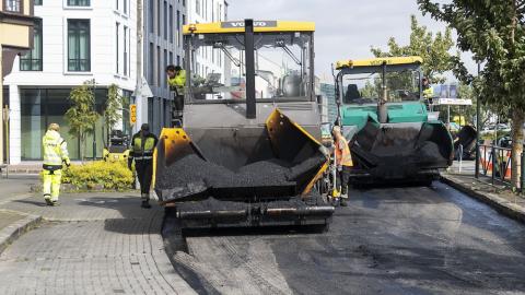Large equipment paving a street