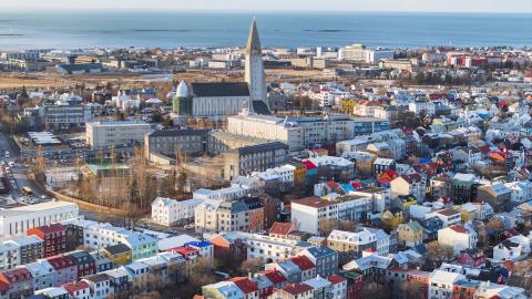 Aerial view of Reykjavík looking over the city center, with Hallgrímskirkja in the middle of the frame.